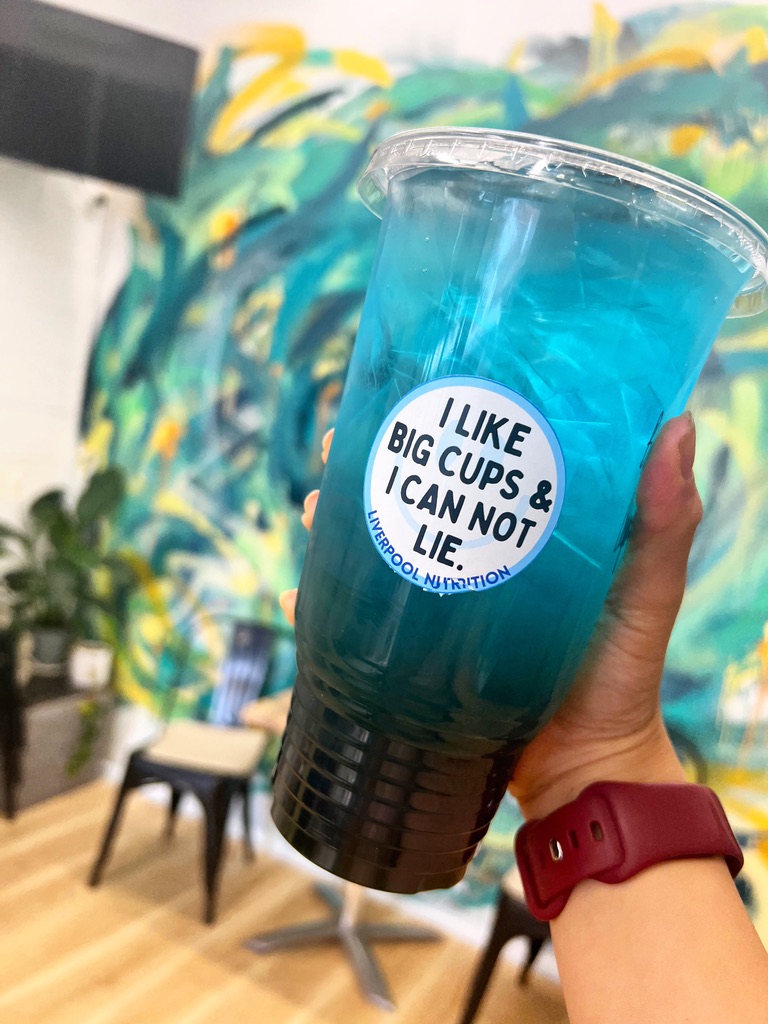 Blue Liverpool Nutrition iced tea held inside the club